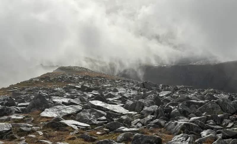 CHANGE ON THE WAY: Swirling cloud resembling huge waves crashing on to shore on summit ridge of Cona' Mheall