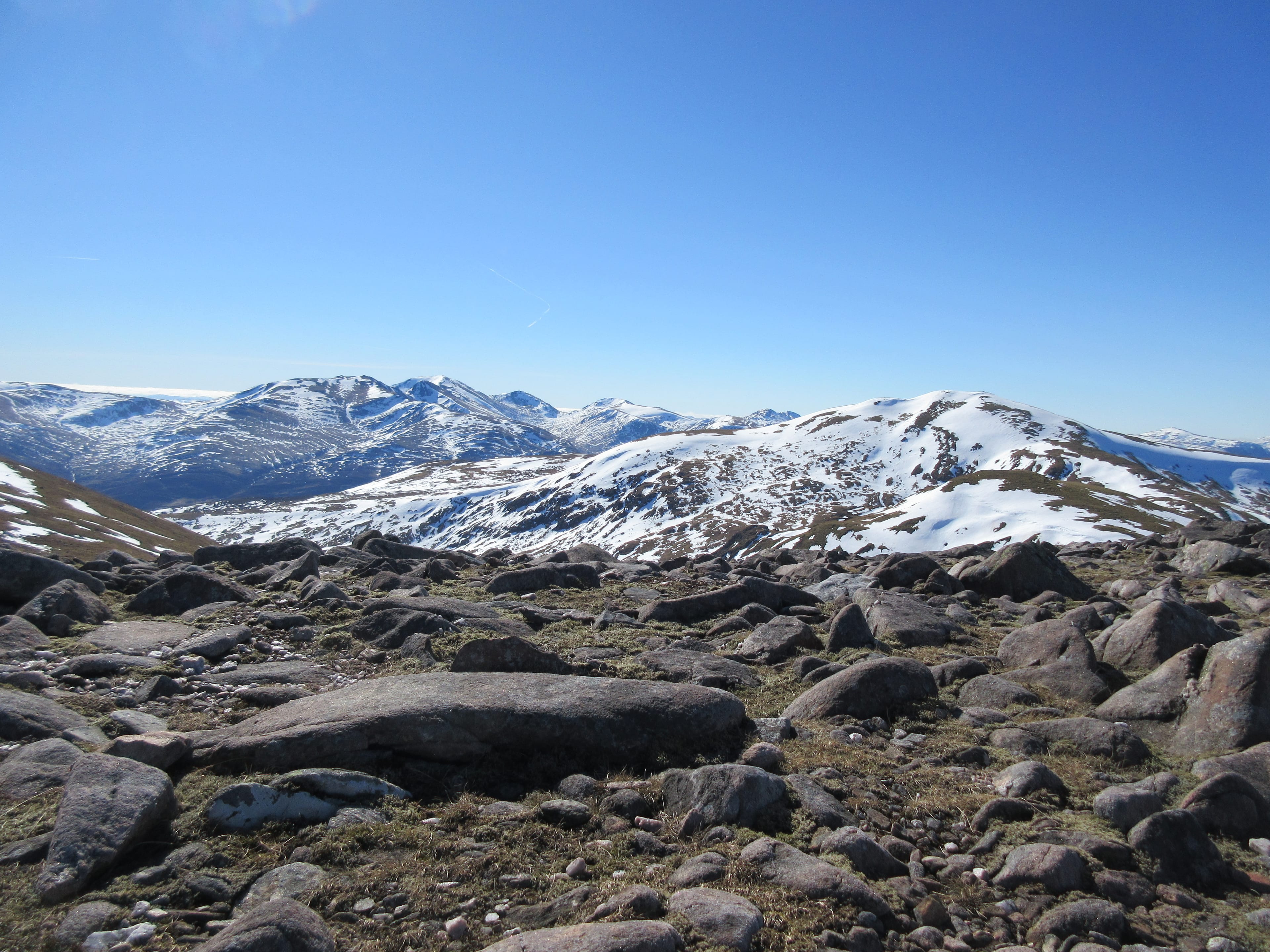 SUNSHINE AND SNOW: Looking back to Carn Gorm and the snow-capped mountains beyond from the summit of Meall Garbh 