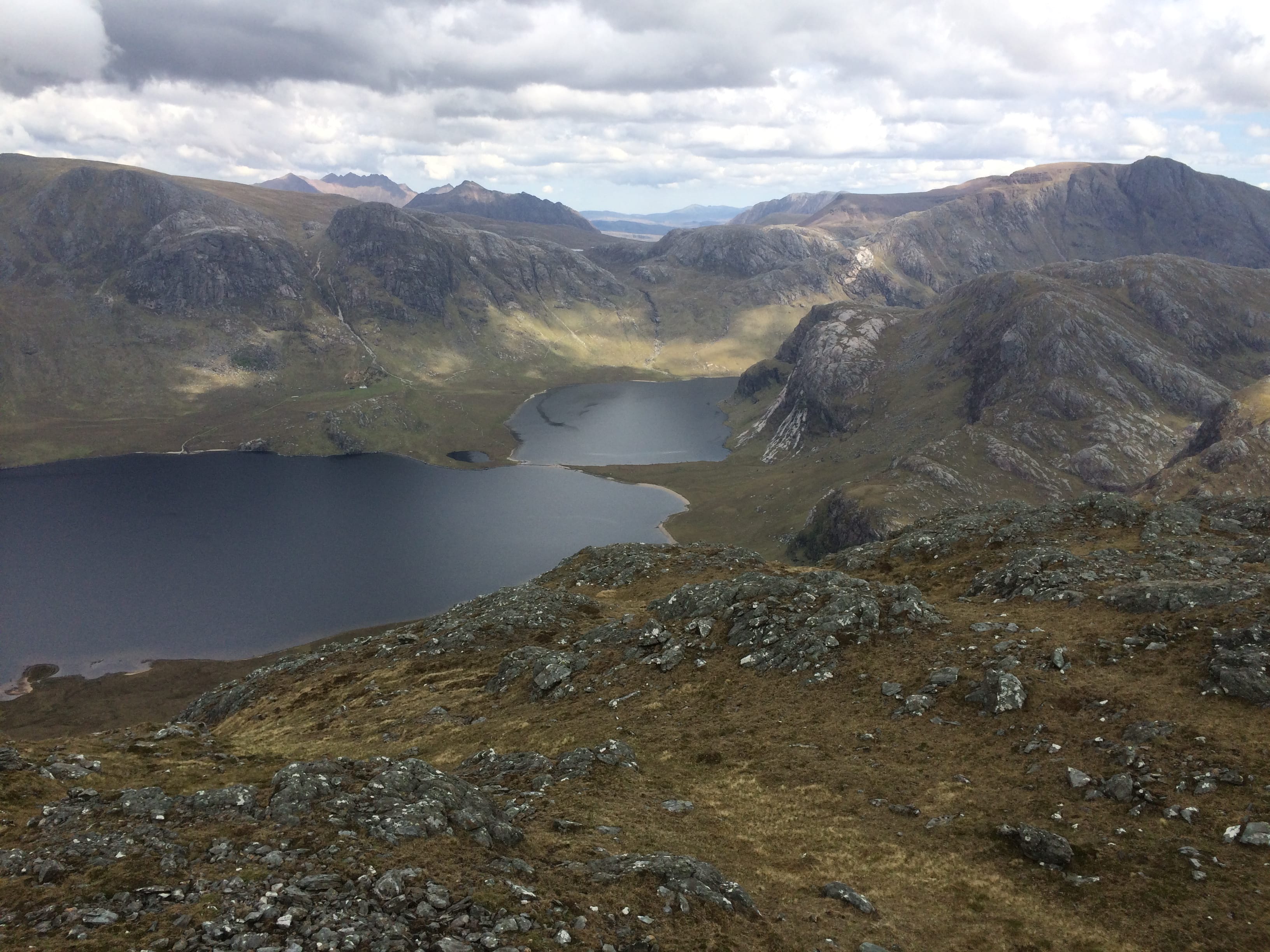 CROSSOVER: Looking down to the causeway over the lochs from summit of Meall Mheinnidh, with A'Mhaighdean and An Teallach prominent 