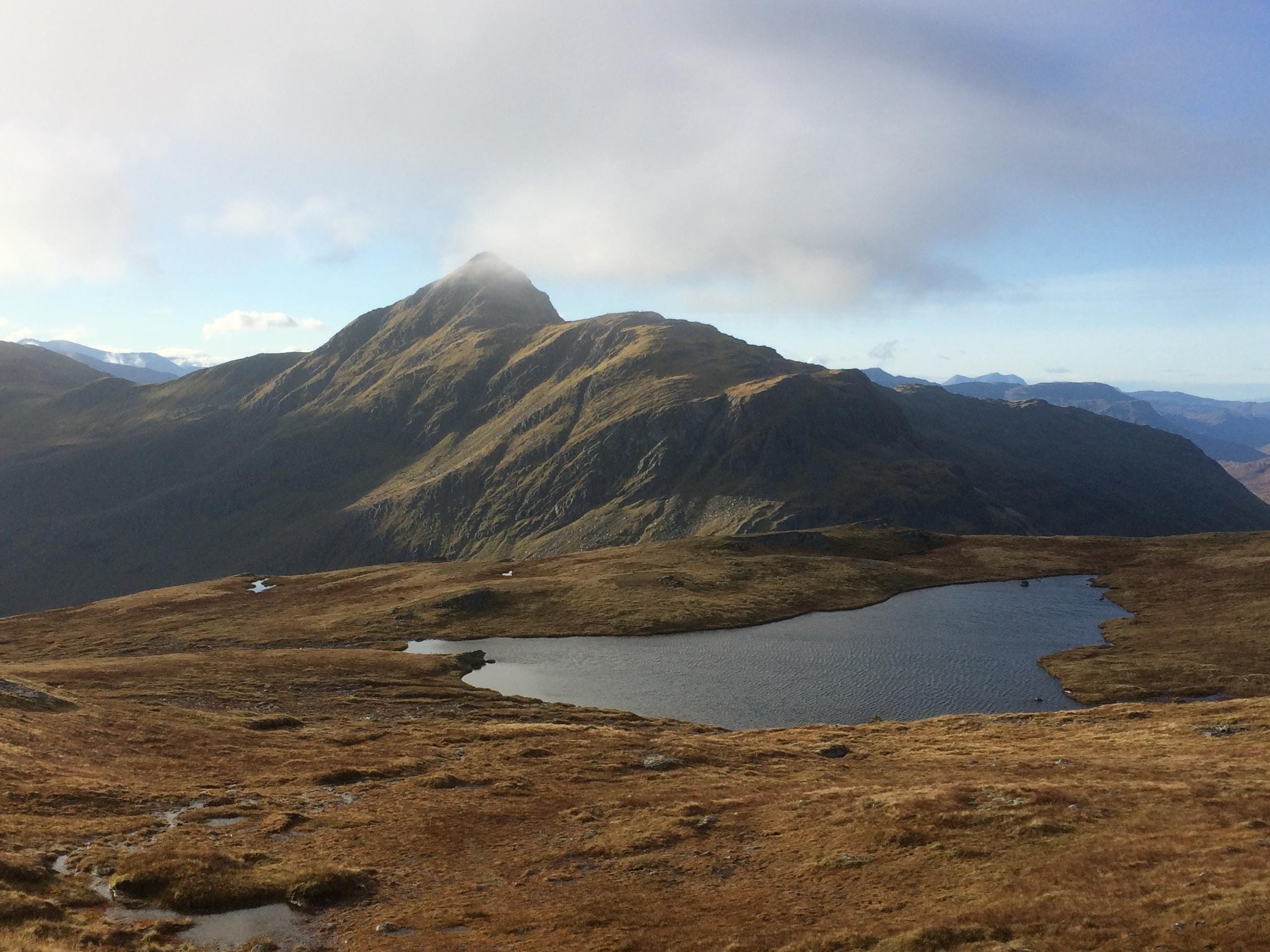 FINEST PROFILE: The steep and intimidating approach to Bidein a' Choire Sheasgaich is first revealed from slopes of Beinn Tharsuinn