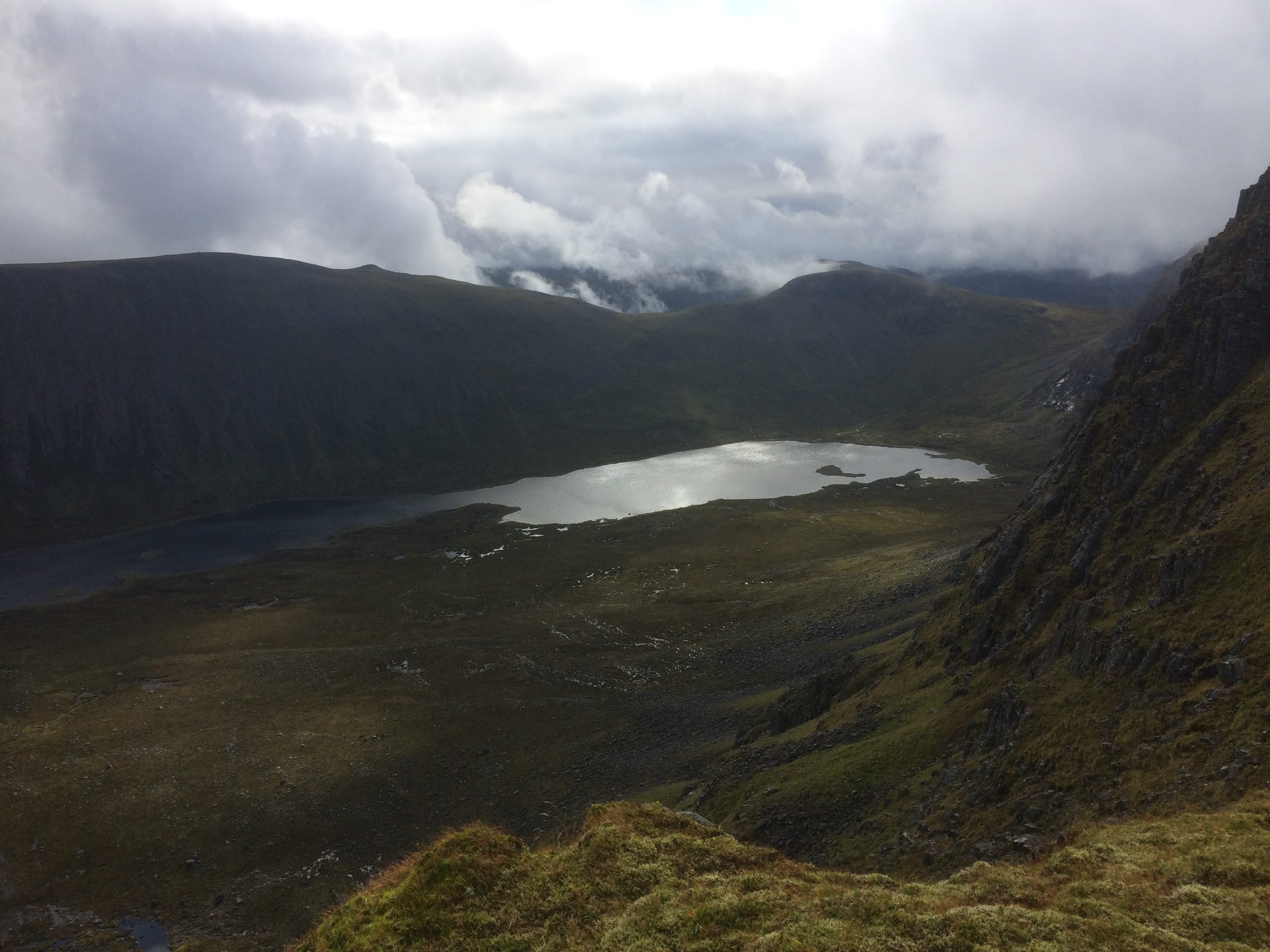 THE END IS IN SIGHT: Looking across to Beinn Bheoil under moody skies from the summit plateau of its neighbour Ben Alder