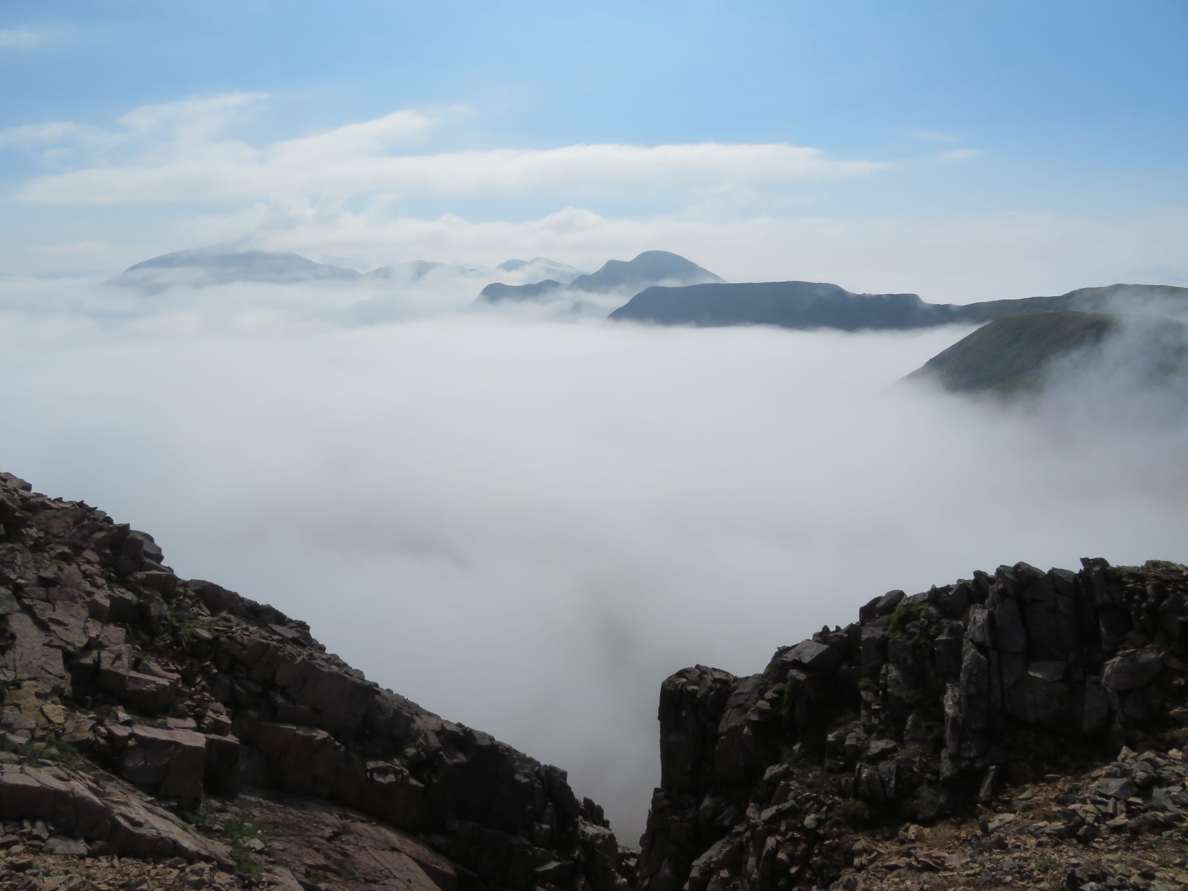 LOST WORLD: The peaks of the Mamores ridge burst through the early mist on final rise to Mullach nan Coirean