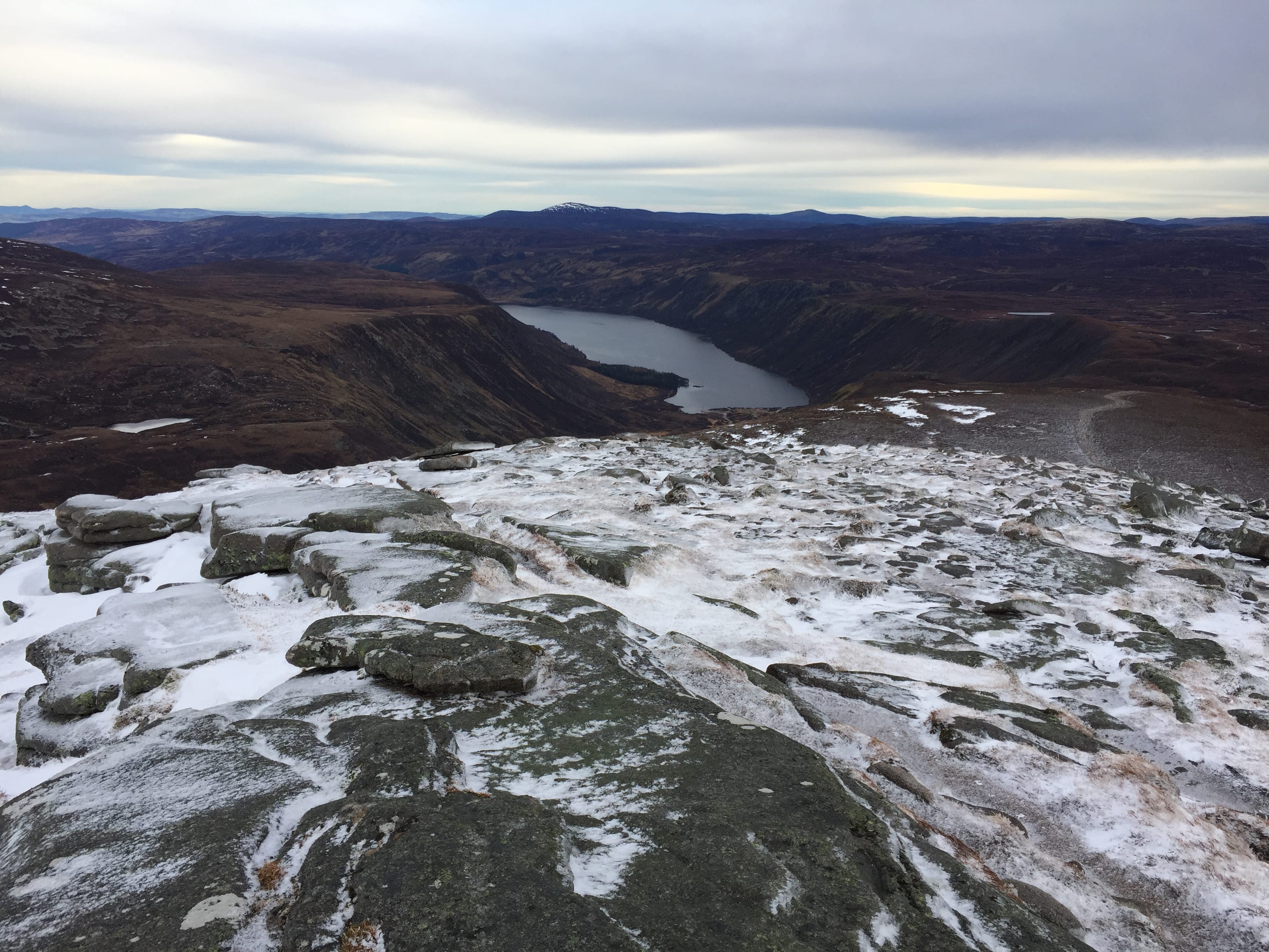 'COOL WATERS: Looking down to Loch Muick from our perch on the snowy summit rocks of Broad Cairn'