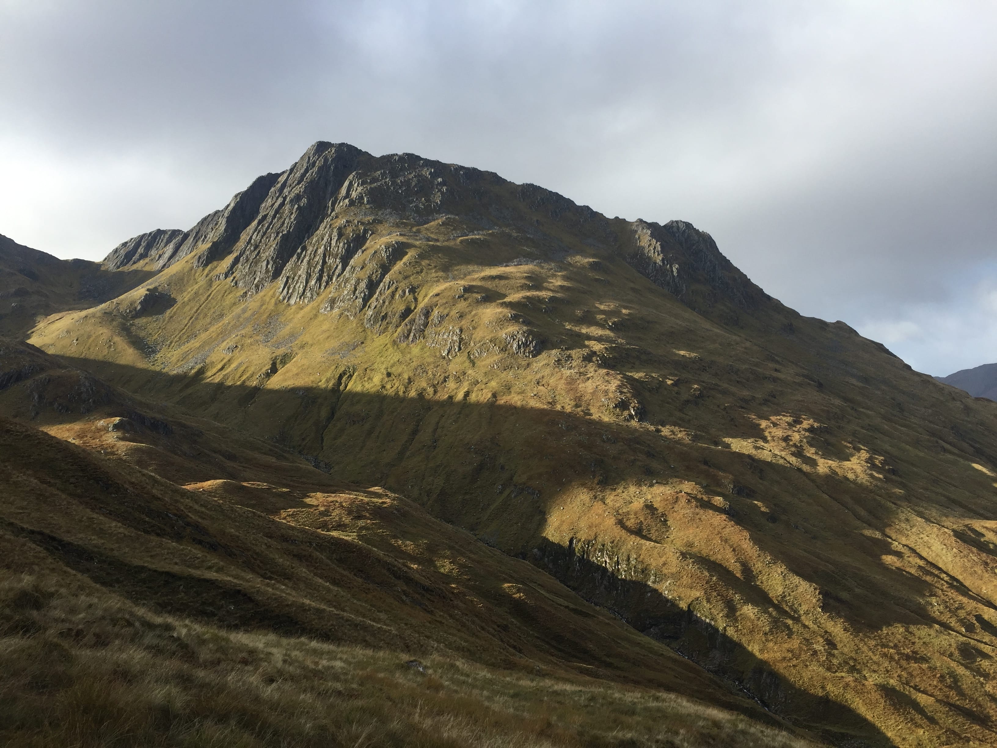 GLOWING PAINS: Bands of autumn sunlight on the slopes of Beinn Fhada during the push up from the bealach