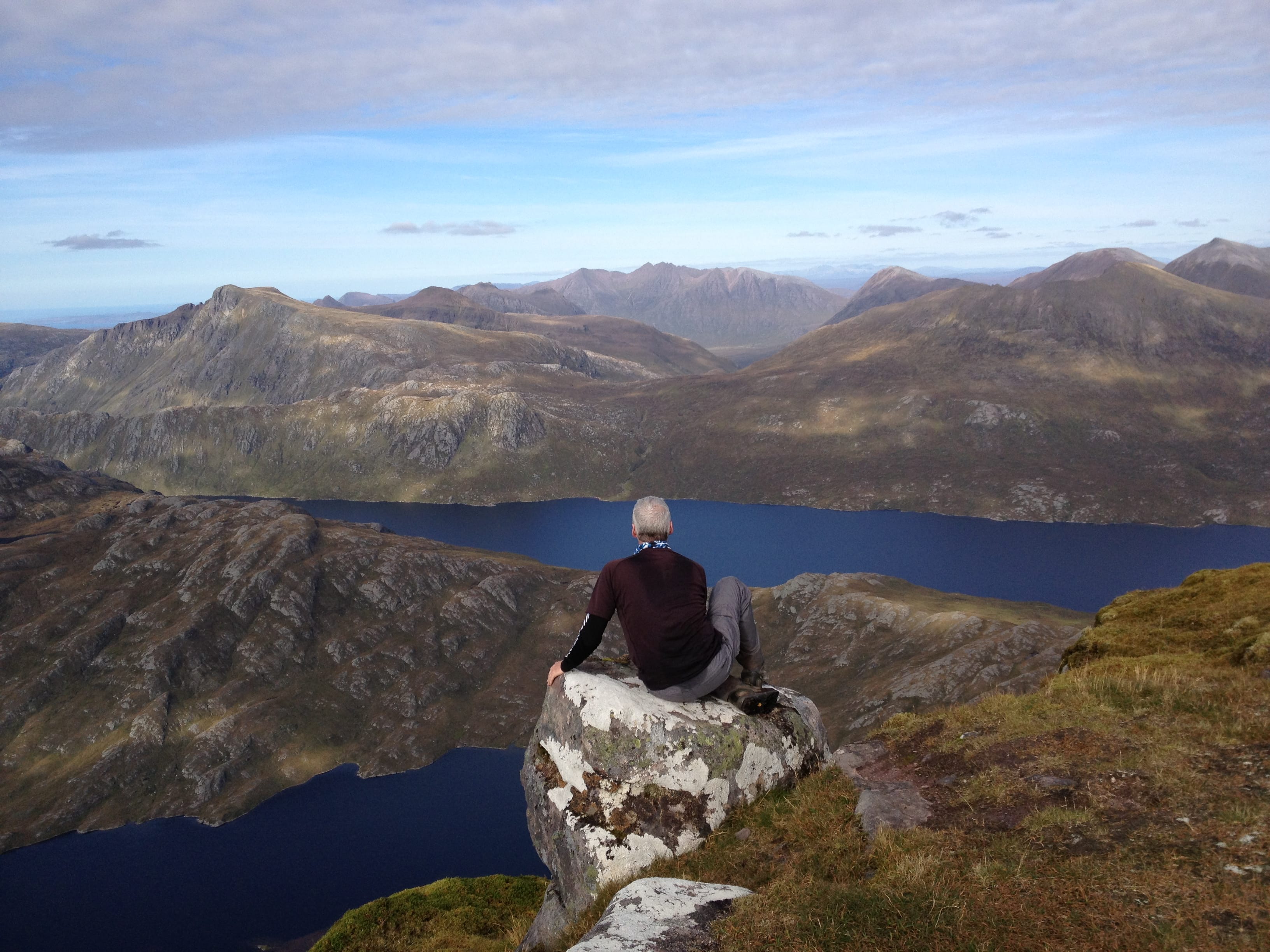 'CAUGHT IN THE MOMENT: Sitting alone with my thoughts at the summit of Slioch, drinking in the perfect view of the Fisherfield peaks'