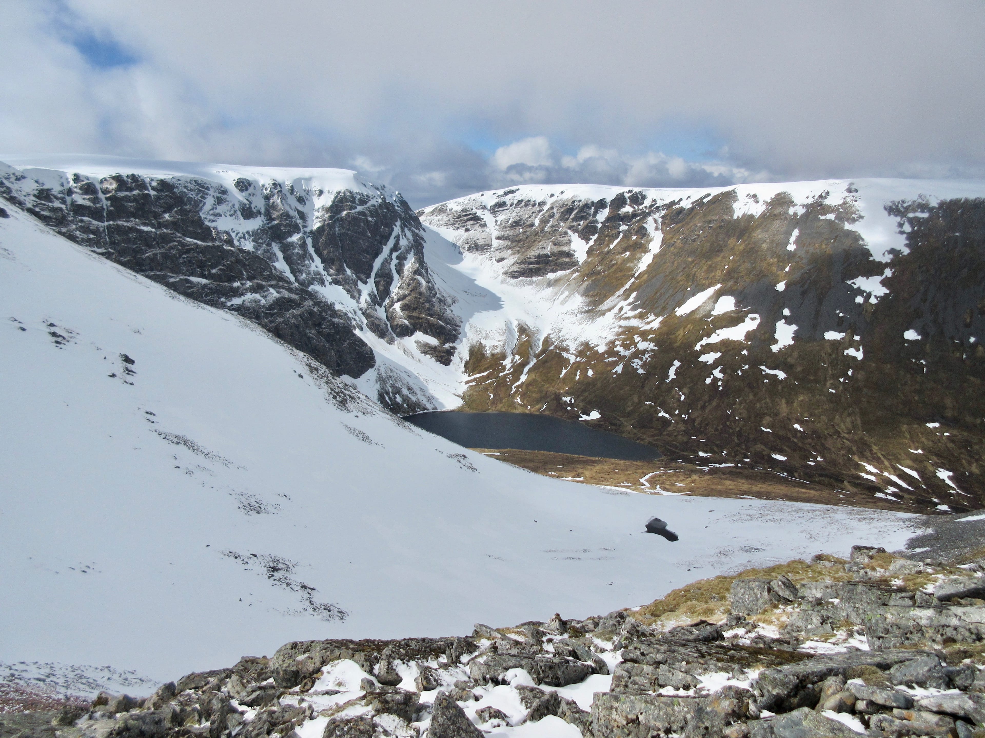 WINDOW DISPLAY: Looking over to the nick in the skyline of snow-streaked faces with the dark waters of the lochan below