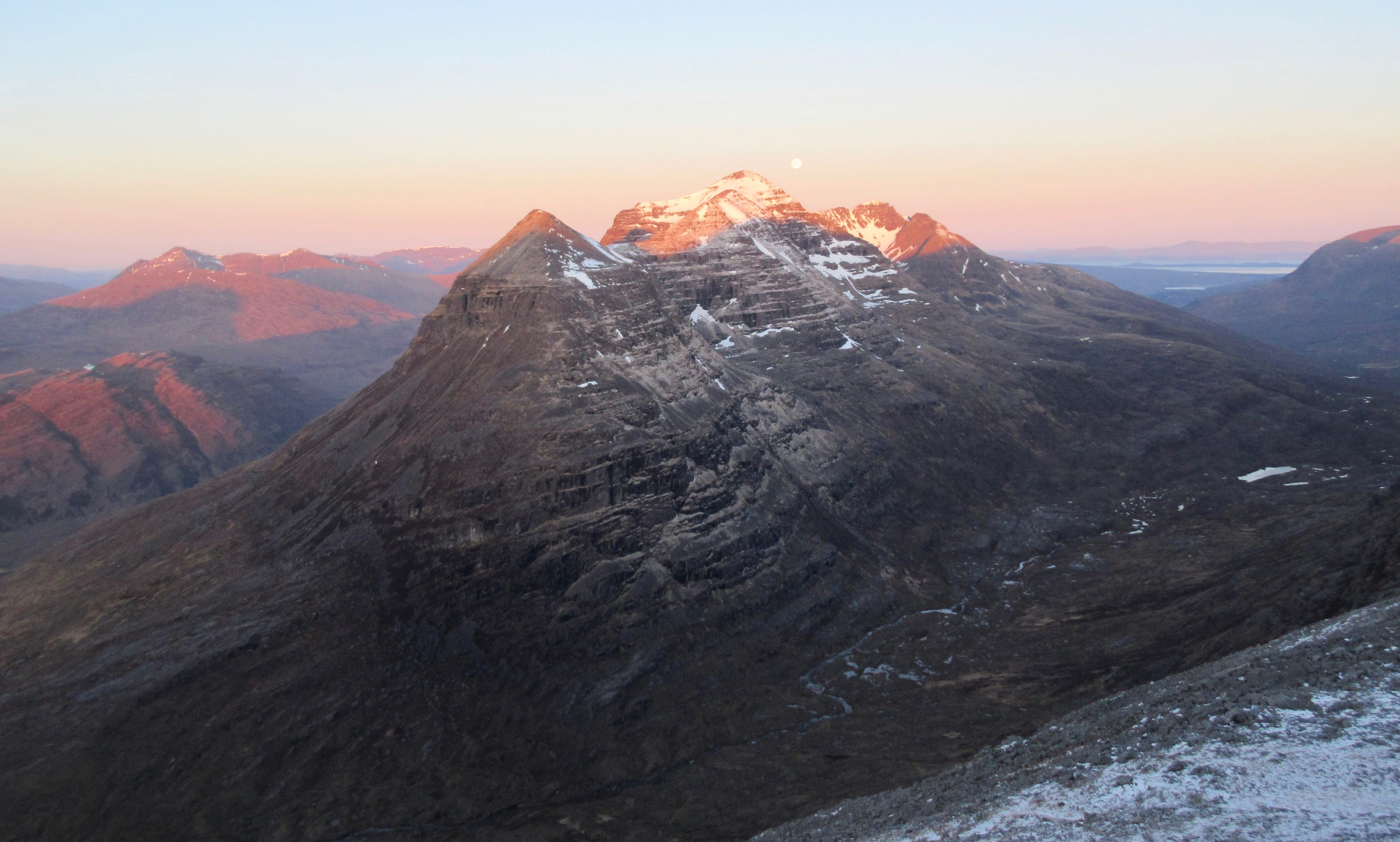 COVER STAR: Liathach's towers glowing red at sunrise from the summit ridge of Beinn Eighe, the cover shot for 2019