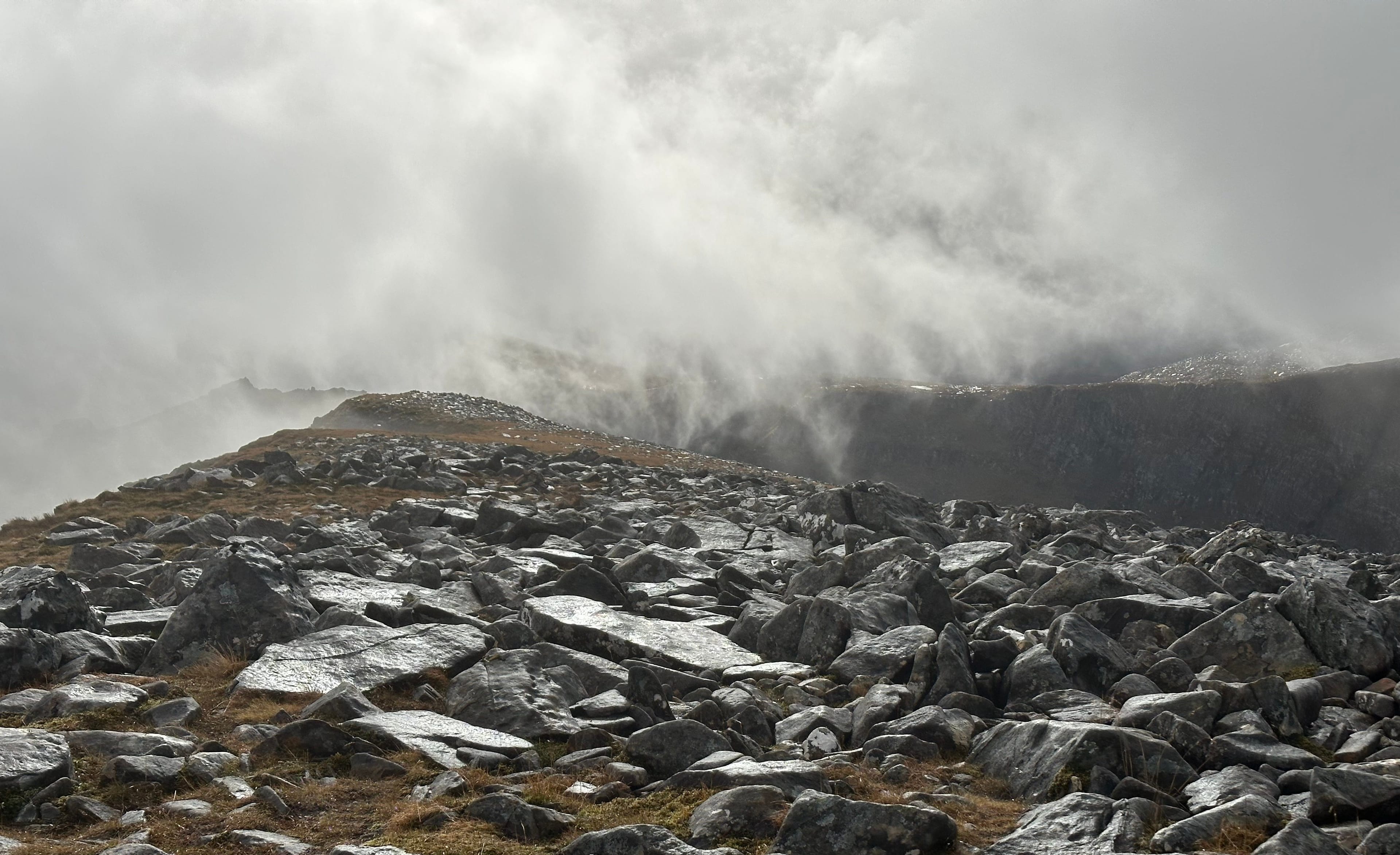 CHANGE ON THE WAY: Swirling cloud resembling huge waves crashing on to shore on summit ridge of Cona' Mheall